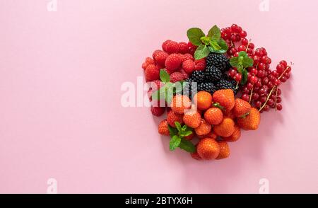 Mix of different berries on the pink. Stock Photo