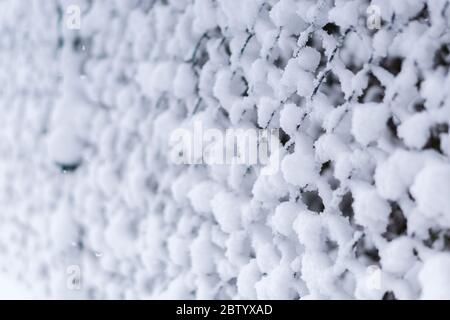 snow covered chain link fence in Lower Bavaria Germany Stock Photo