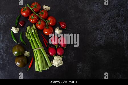 Fresh raw vegetables on black background view from above.  Stock Photo