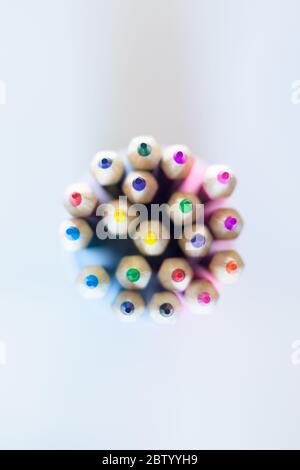 Colored pencils in a glass on top. Multicolored bright for drawing. Stock Photo