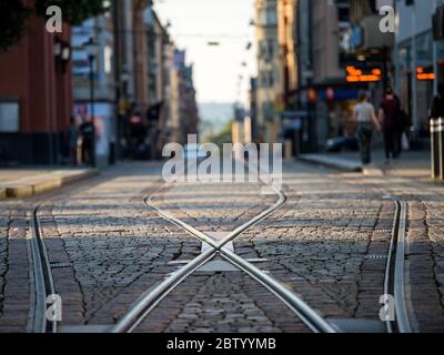Tram tracks on Drottningatan in the city center of Norrkoping, Sweden. The yellow trams are iconic for Norrkoping. Stock Photo