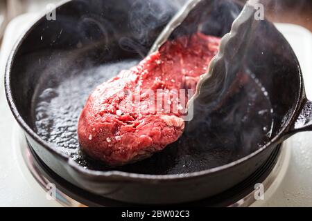 Seasoned raw beef steak with spices Stock Photo