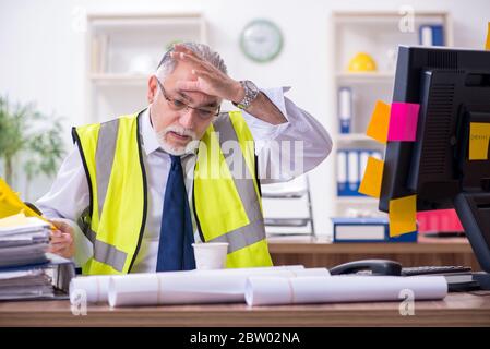 Old male architect working in office Stock Photo