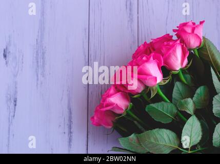 Beautiful fresh spring roses on a grey background Stock Photo