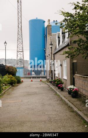 View from Fittie, a small traditional North Sea fishing village in Aberdeen, towards the industrial oil and gas terminal of the main harbour. Stock Photo