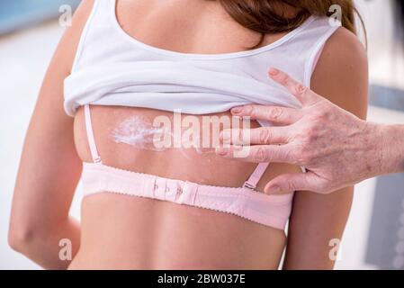 Young woman visiting old doctor dermatologist Stock Photo