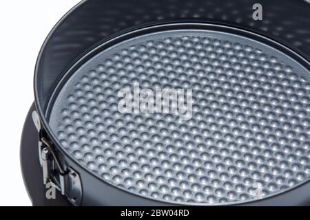 Teflon round collapsible mold isolated on white background. Stainless steel roasting pan Stock Photo