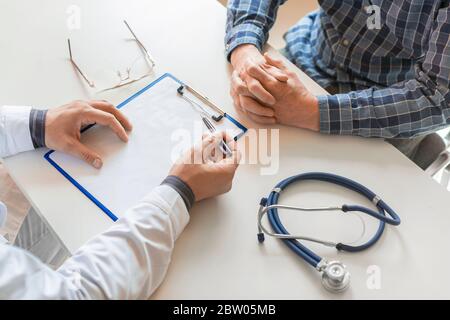 the doctor tells the patient about his illness and the possibilities of his insurance. Healthcare concept. Stock Photo