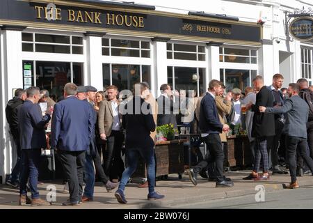 Large group of people socialising and drinking outside JD Wetherspoons public house The Bank House in Cheltenham Town Centre Stock Photo