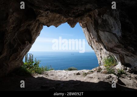 View looking out from one of the Goats Hair Twin Caves in Gibraltar Stock Photo