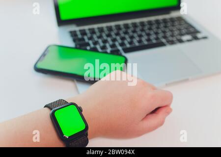 watch by use multiple internet electronic devices with green screen Stock Photo