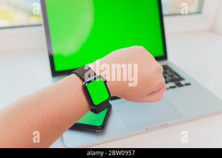 watch by use multiple internet electronic devices with green screen Stock Photo