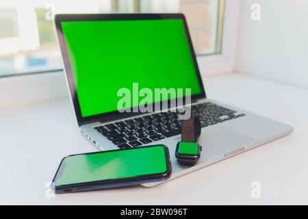 watch by use multiple internet electronic devices with green screen Stock Photo