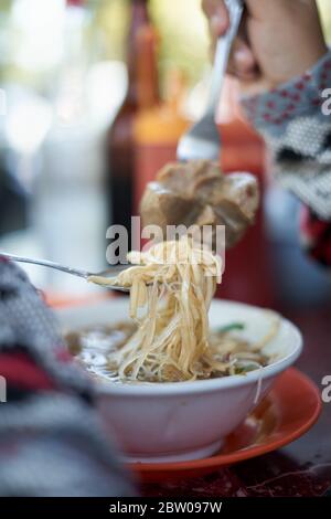 Noodles soup with meatballs and vegetable on a plate. Tasty asian food Stock Photo