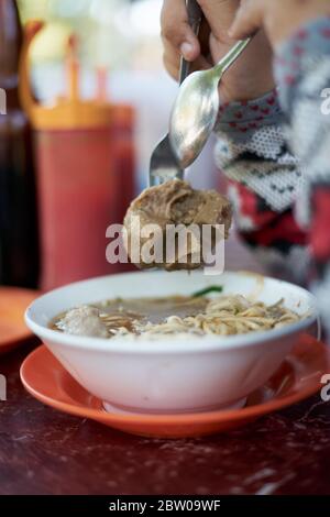Noodles soup with meatballs and vegetable on a plate. Tasty asian food Stock Photo