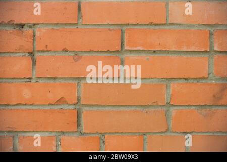 Orange bricks wall close up background. Stained old brick wall texture. Stock Photo