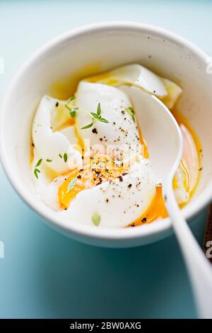 Soft boiled eggs with pepper and thyme Stock Photo