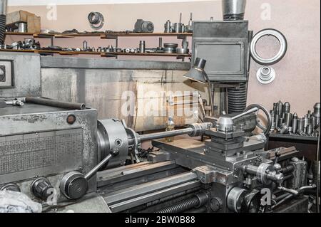 old Metalworking machine is working. Turning production. Using old technologies in times of crisis and stagnation. Stock Photo