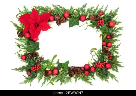 Thanksgiving & Christmas festive border with red poinsettia flower, bauble decorations & winter greenery on white background. Stock Photo