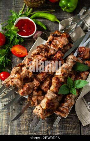 Summer Barbecue menu. Grilled meat skewers on rustic wooden table. Stock Photo