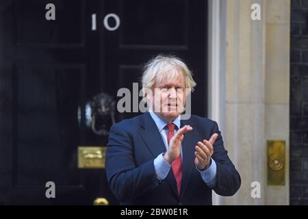 Prime Minister Boris Johnson joins in the weekly Clap for Carers outside his official London residence in Downing Street. Stock Photo
