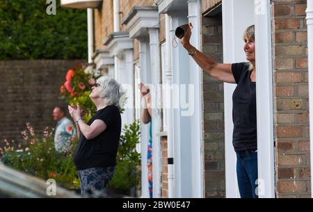 Brighton UK 28th May 2020 - Residents and neighbours of Queens Park in Brighton join in the Clap For Our Carers for NHS staff and Key Workers tonight during the coronavirus COVID-19 pandemic . : Credit Simon Dack / Alamy Live News Stock Photo