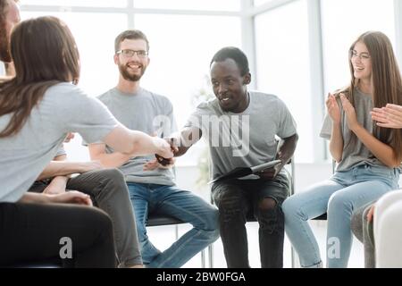 group of young people greeted the speaker with their applause Stock Photo