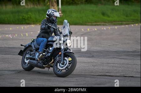 Bikers driving a motorcycle rides along the asphalt road Stock Photo