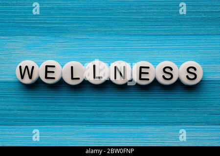 Wellness text on a blue wooden table Stock Photo