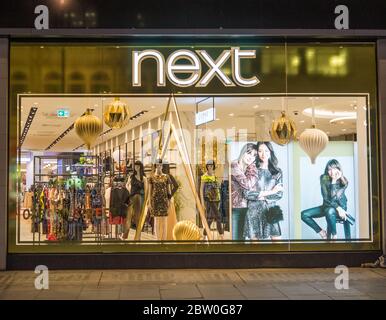 Retail store Next window display at night on Oxford Street. London Stock Photo