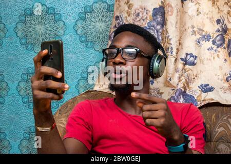 young black man making a video call, wearing headphones Stock Photo