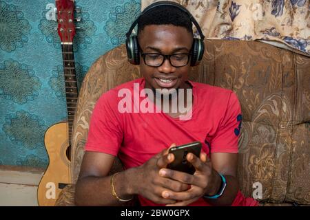 african man making a live video, wearing a headphones, indoors, talking on phone concept Stock Photo