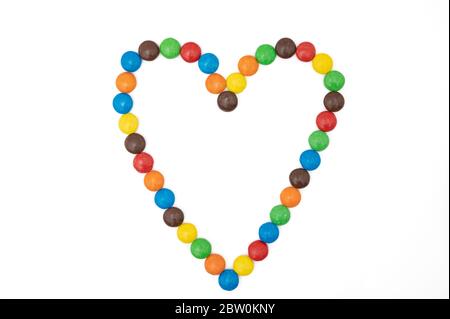Heart shape made of colorful candies on white background Stock Photo