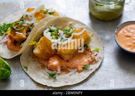 Fish tacos with cod, harrisa sauce, pickled onions and chili Stock Photo