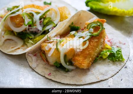 Fish tacos with cod, harrisa sauce, pickled onions and chili Stock Photo