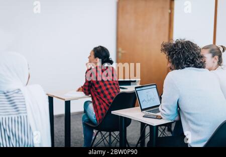 Young diverse team of people using laptops in a training session Stock Photo