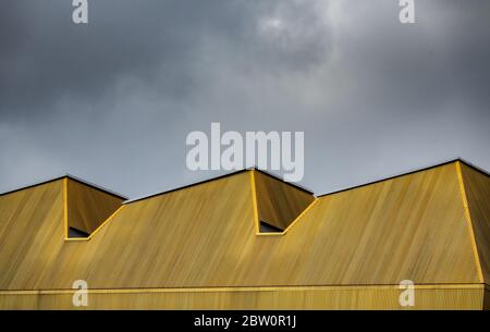 Abstract Architecture Image Of An Urban Modern Yellow Roof Against A Cloudy Sky Stock Photo