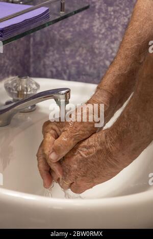 Hands under running water faucet Stock Photo