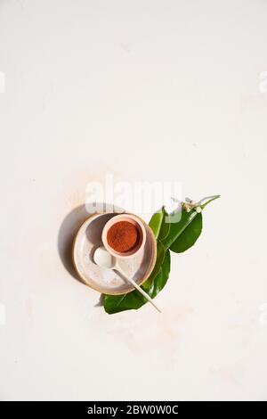 Spices and lime leaves with beautiful handmade ceramic dishes on white Stock Photo
