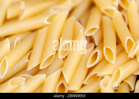 penne lisce - traditional italian pasta of durum wheat, food background Stock Photo