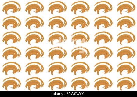 Pattern from abstract image of handful of golden coloured sand. Top view on isolated white background. Abstract golden ox. Symbol of Christmas. Stock Photo