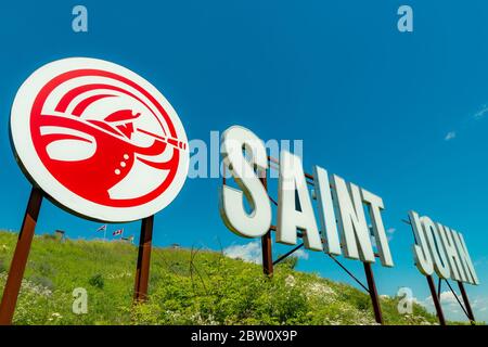 Saint John, NB, Canada - July 20, 2019: The "Saint John" sign overlooks the harbor from Fort Howe. The cities "Loyalist" logo is to the left of the si Stock Photo