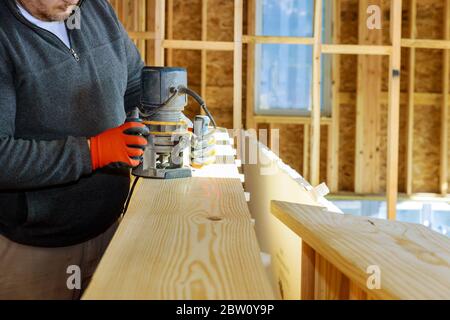 Trimmer for woodworking making curved edges electric powered router on wood a small woodwork Stock Photo