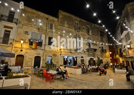 Bari Old Town (Citta Vecchia), with people having dinner on the street, Italy Stock Photo