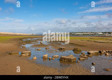 An early morning walk on a beautiful sunny day along the causeway overlooking the huge Fleet lagoon while the tide is out Stock Photo