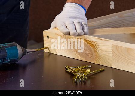 Closeup of professional cabinet makers working with electric circular saw at woodworking workshop. Wood material production. Lumber factory Stock Photo