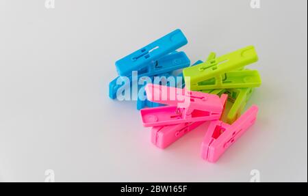 The multi-colored clothespins on a white background Stock Photo