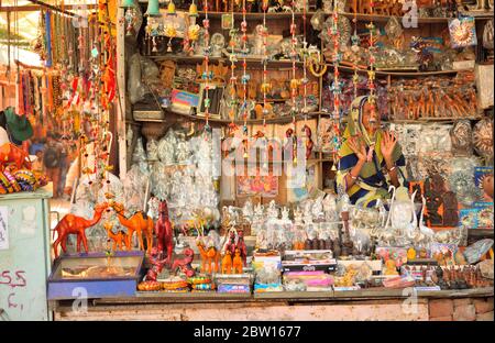 A woman selling decorative items and souvenirs in her shop. Stock Photo