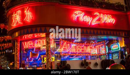 Neon shop signs of Play 2 Win amusement arcade in China Town at night. London Stock Photo