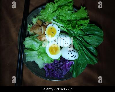 Vegetable salad with basil and eggs in plate - healthy vegetarian vegan diet organic food.Top view. Flat lay Stock Photo